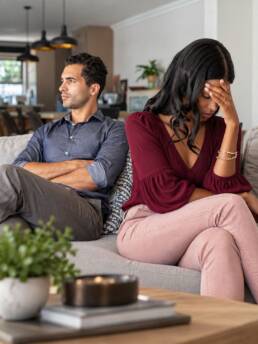 Tense Couple on the Living Room Sofa